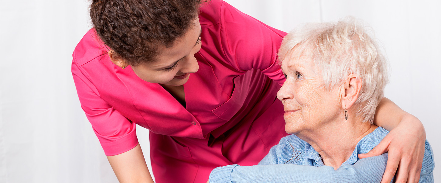 Pflegekraft mit Seniorin